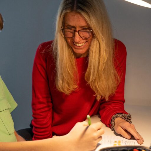 Schulbegleiterin hilft Kind beim Schreiben – individuelle Förderung bei schulemitplus
